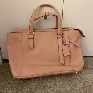 Tumi pink travel bag with luggage handle slip